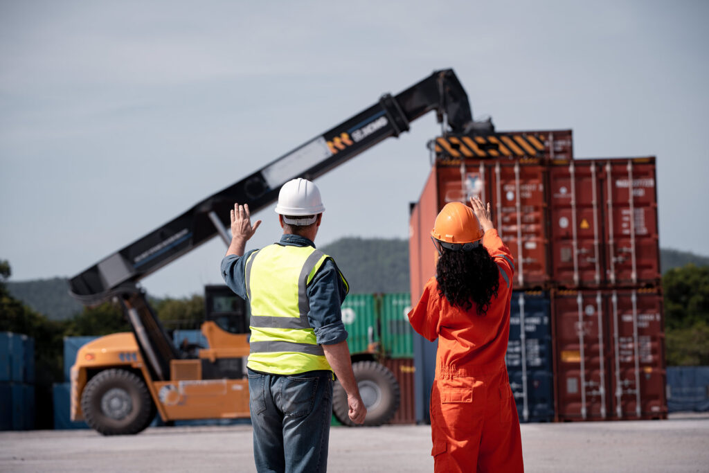 Engineer Worker Operating a Forklift with Containers in a Warehouse