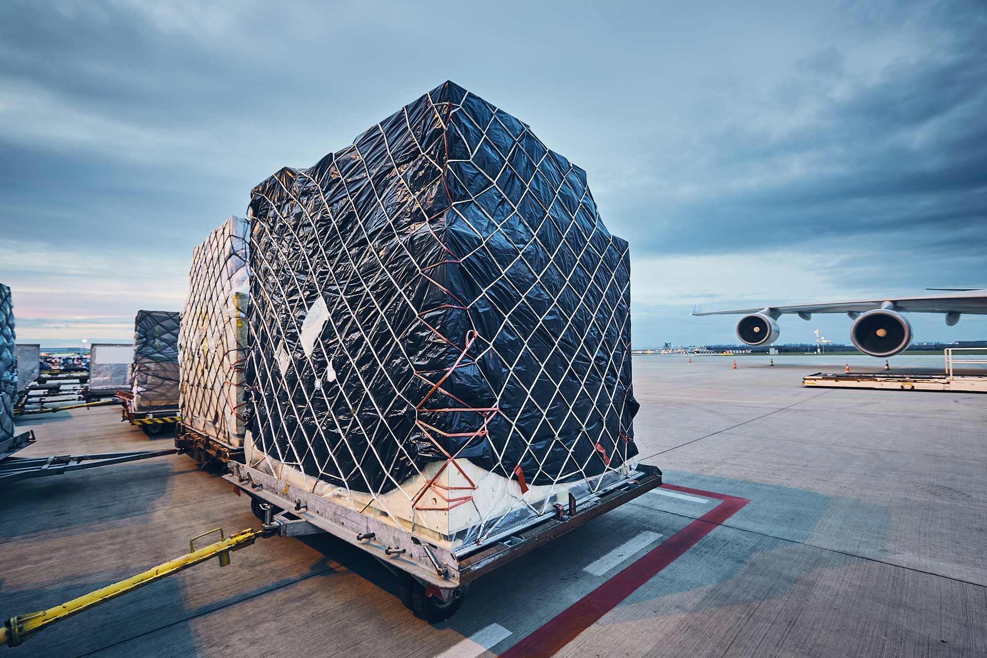Loading Cargo onto an Airplane at a Busy Airport
